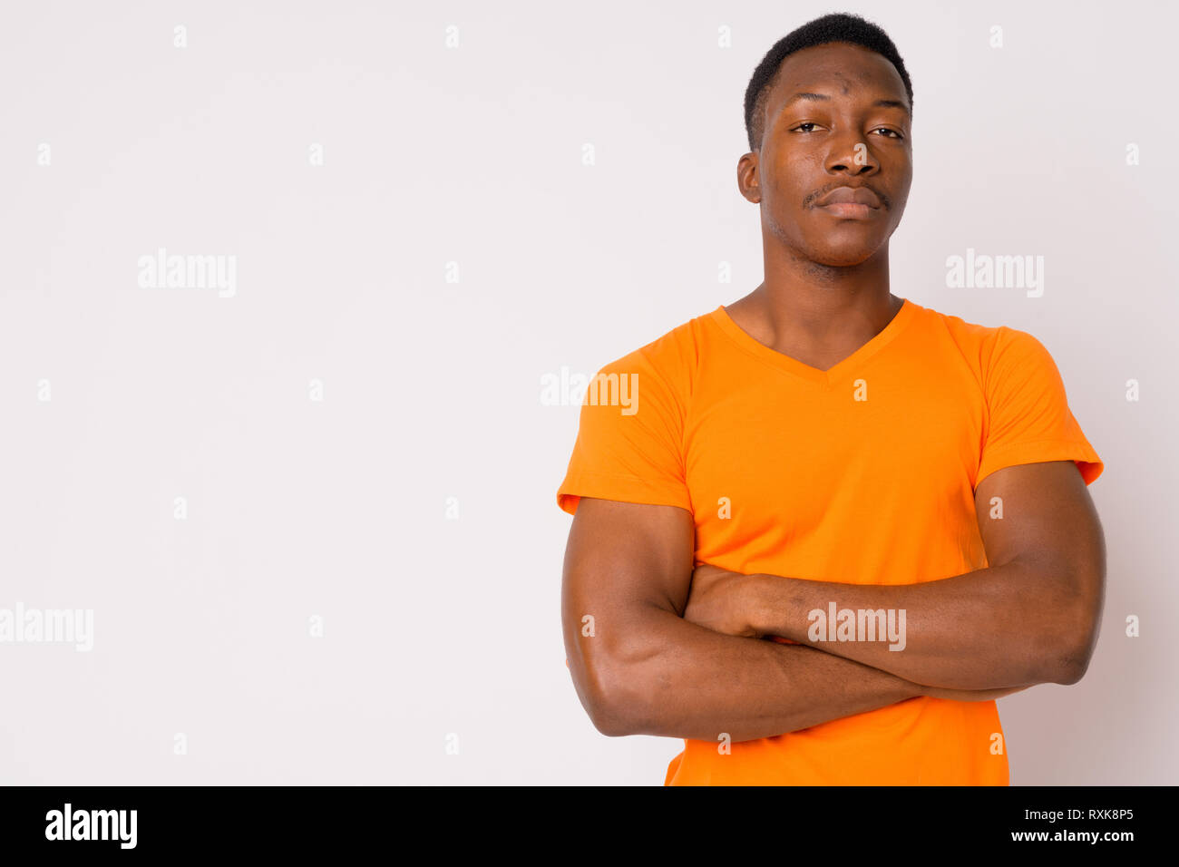 Portrait of young handsome African man with arms crossed Stock Photo ...