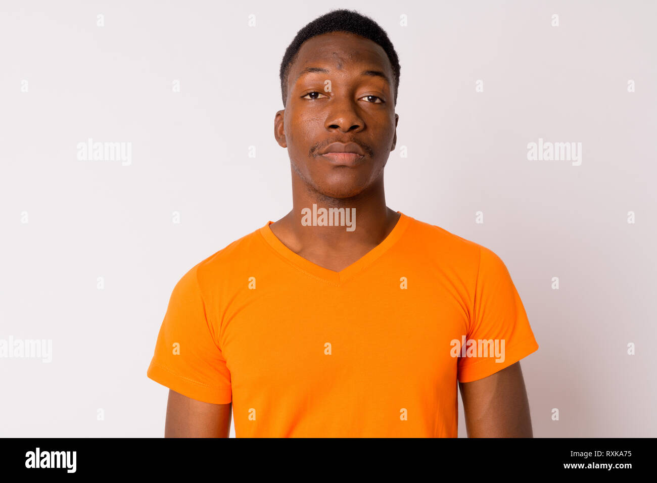 Face of young handsome African man wearing orange shirt Stock Photo - Alamy