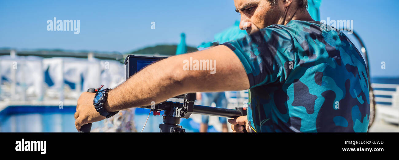 Stabilizer Operator Steadicam operator and his assistant prepare camera and 3-axis ...