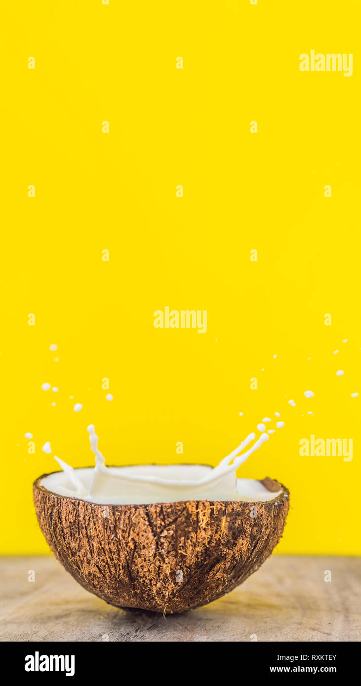 Coconut fruit and milk splash inside it on yellow background VERTICAL  FORMAT for Instagram mobile story or stories size. Mobile wallpaper Stock  Photo - Alamy