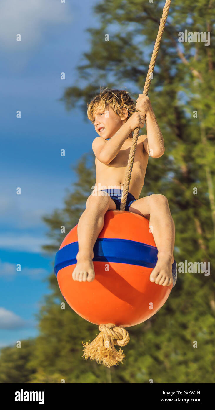 https www alamy com a boy on a swing on the beach mom and son spend time on the beach vertical format for instagram mobile story or stories size mobile wallpaper image240152577 html