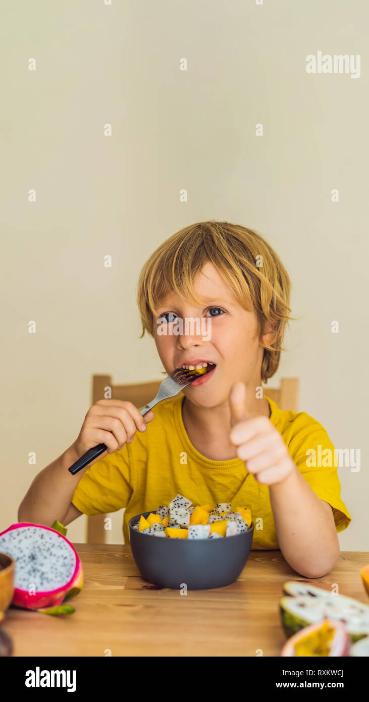 Boy eats fruit. Healthy food for children. Child eating healthy snack
