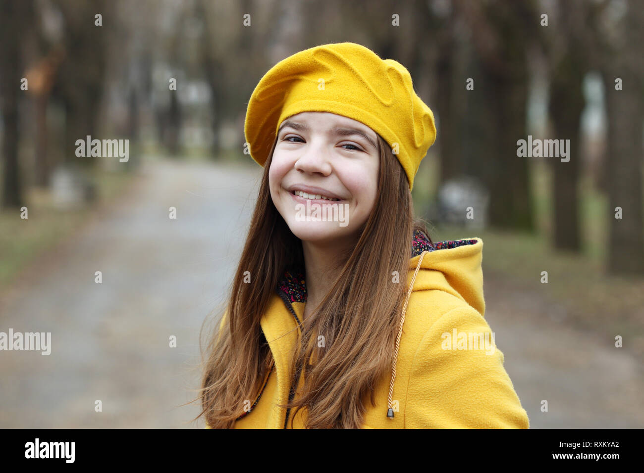 beautiful teenage girl in a yellow coat and beret portrait Stock Photo ...
