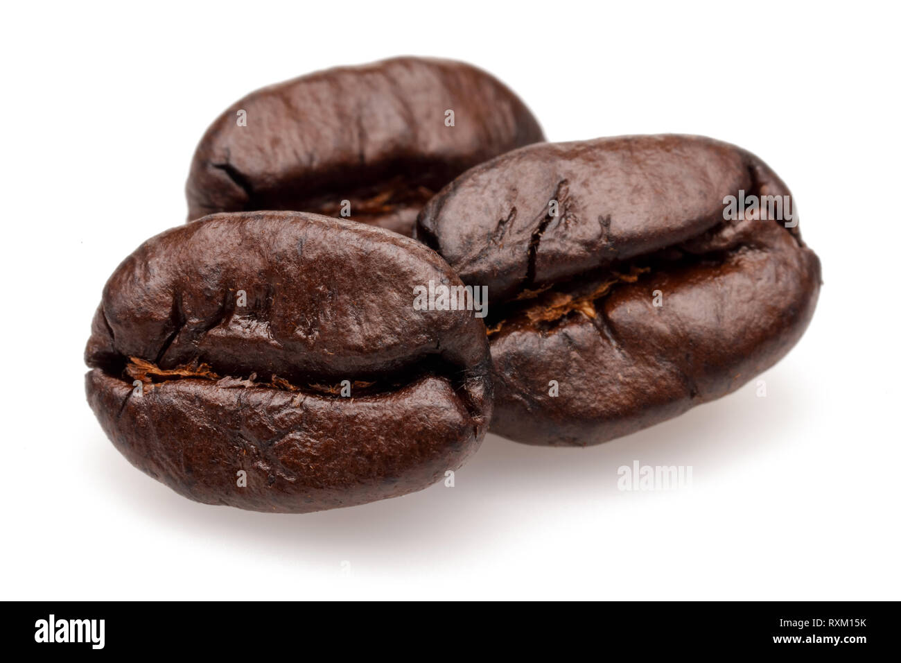 Dark roasted coffee beans isolated on white background Stock Photo - Alamy