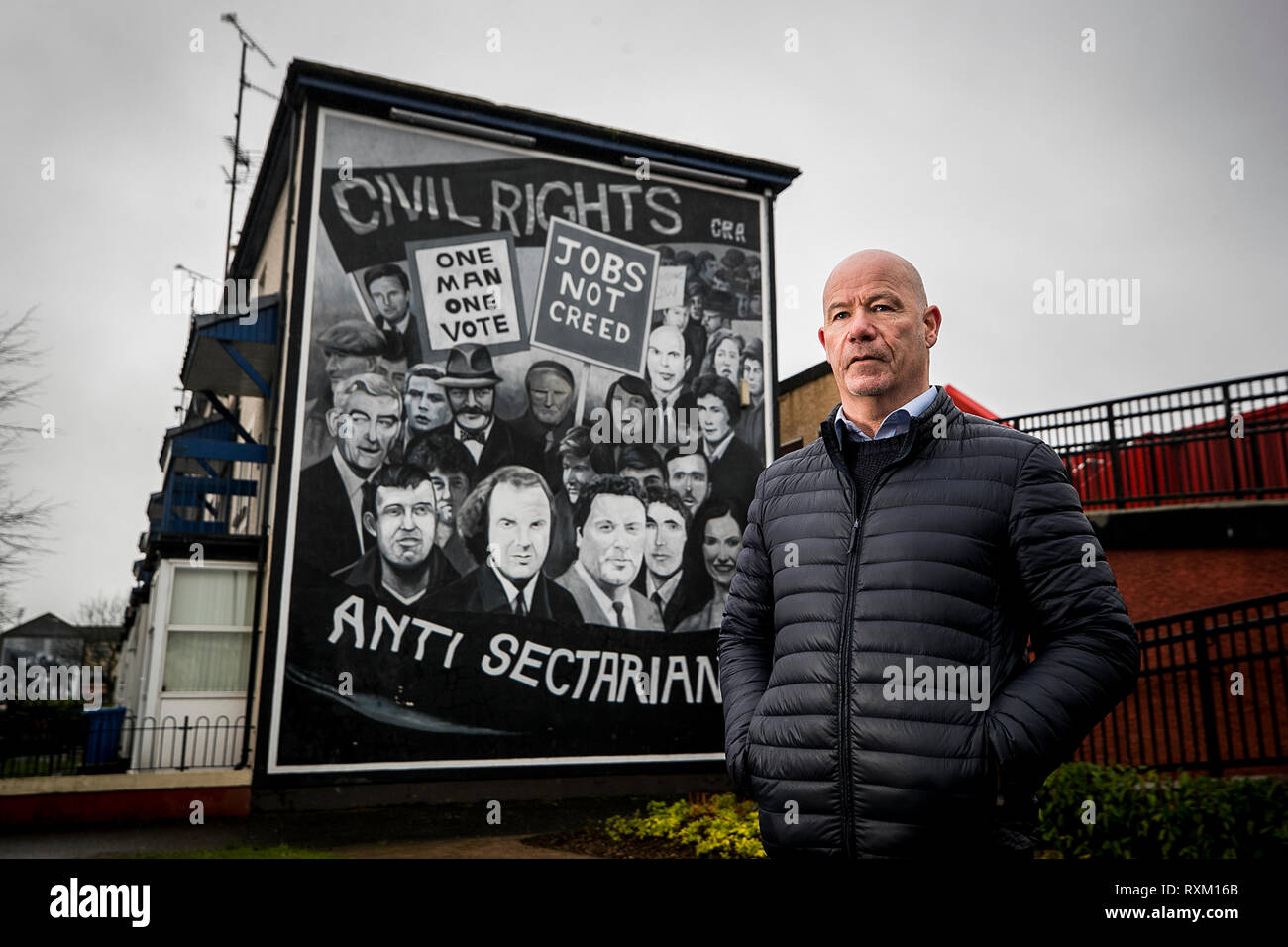 John McKinney whose brother William was killed on Bloody Sunday stands beside the Civil Rights mural in Derry City's Bogside. The Public Prosecution Service is expected to announce whether it will pursue prosecutions against soldiers over the deaths of 13 people in Londonderry on January 30 1972. Stock Photo