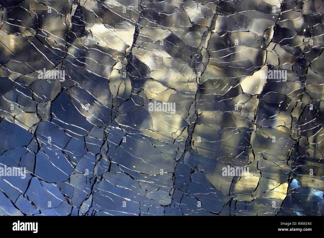 Abstract background of illuminated broken glass. Luxury, creative design backdrop of cracked, shattered glass texture. Stock Photo