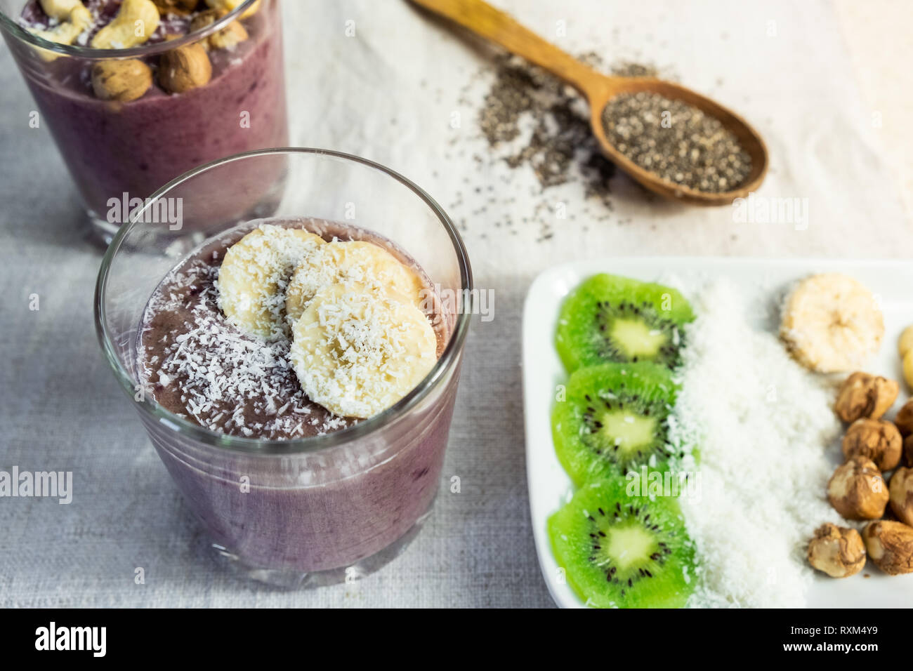 Smoothie bowl breakfast and topping ingredients. Healthy organic raw food meals in natural rustic background Stock Photo