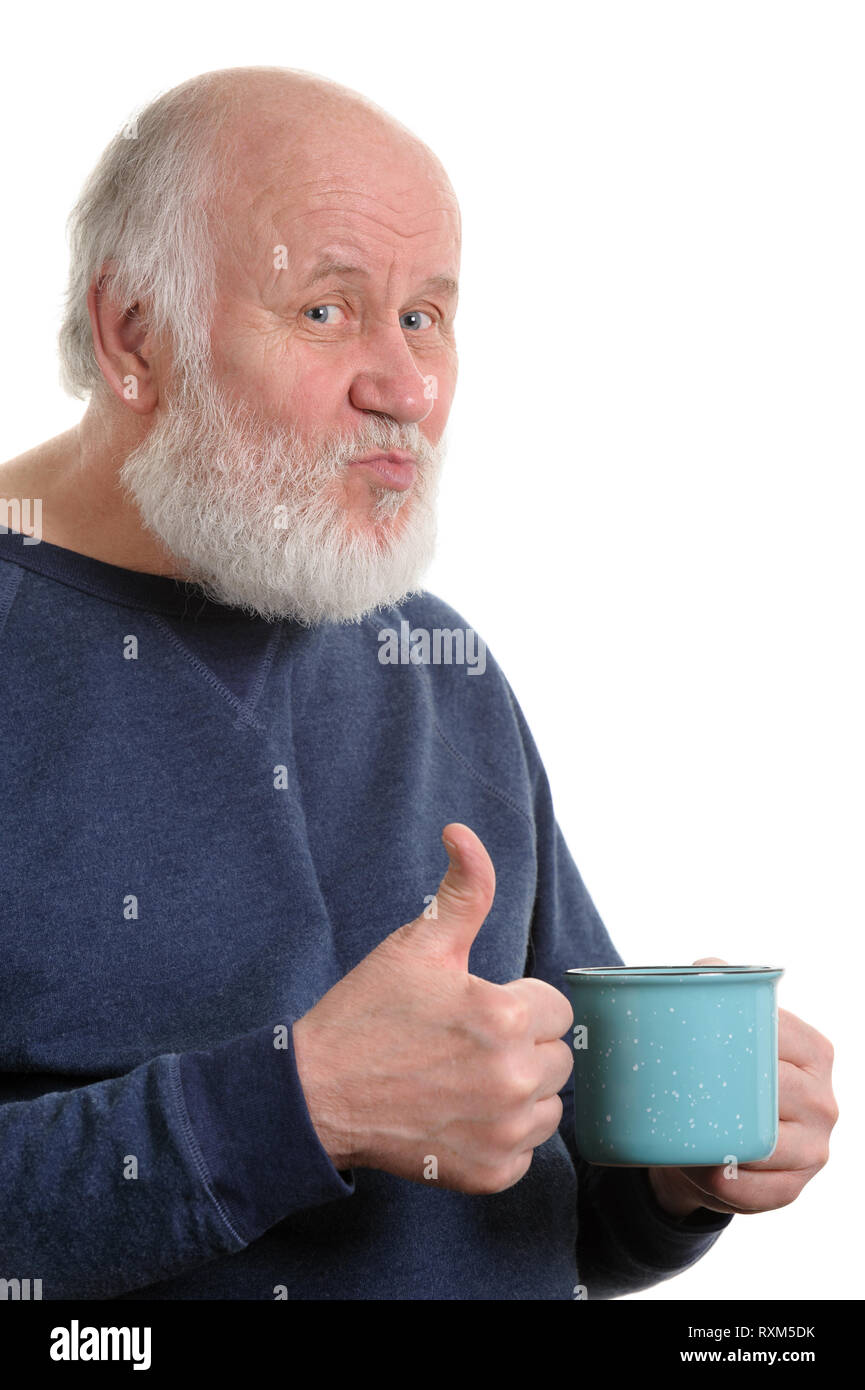 elderly man with cup of bad tea or coffee showing thumb up isolated on white Stock Photo