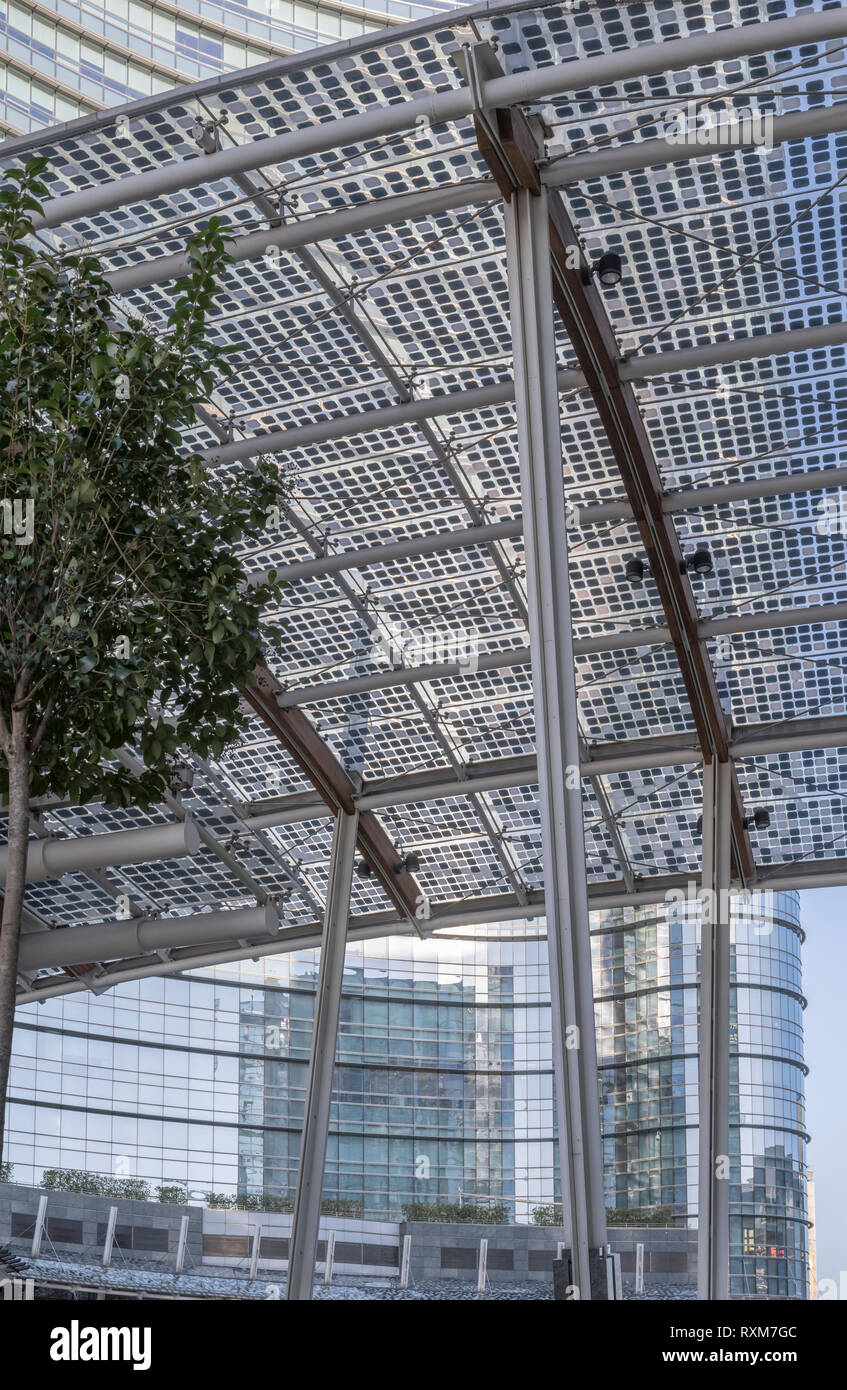 foreshortening of steel canopies and steel and glass facades at new cool business hub in city center, shot in bright winter light at Milan, Lombardy,  Stock Photo