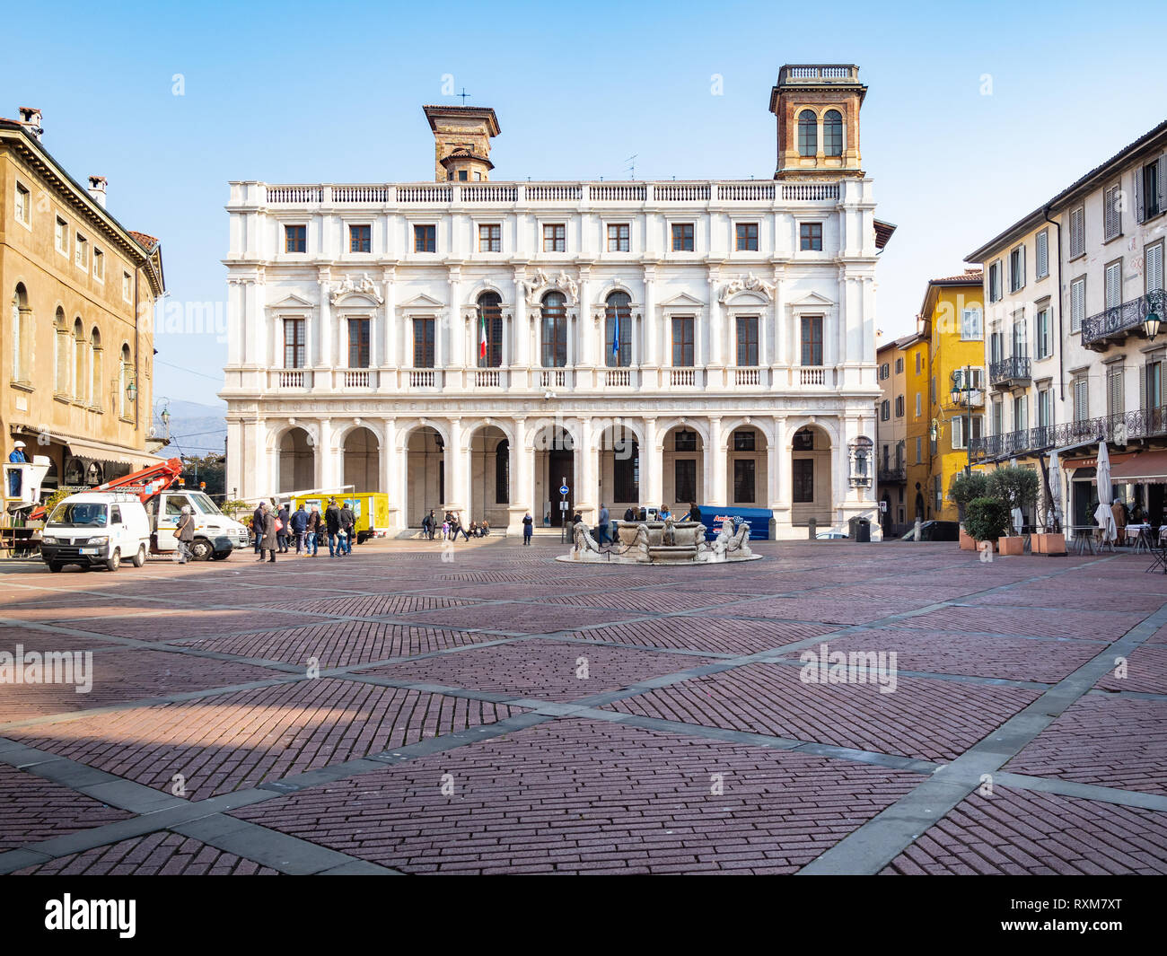 BERGAMO, ITALY - FEBRUARY 19, 2019: tourists on Piazza Vecchia square near Palazzo Nuova ( public library Biblioteca Civica Angelo Mai) in Citta Alta Stock Photo