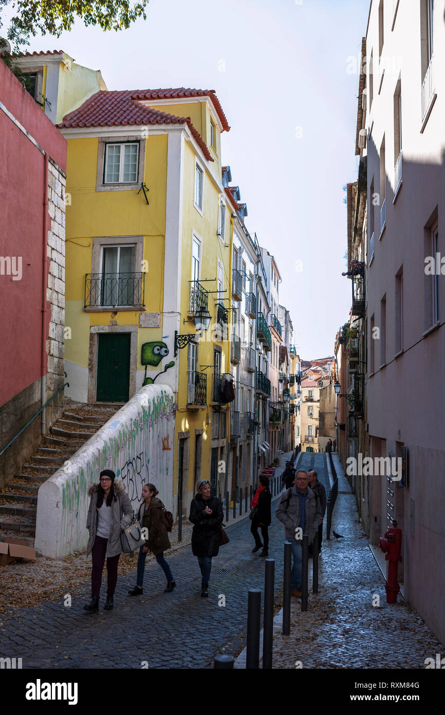 Pedestrians in the street: Rua das Farinhas, Bairro da Mouraria, Lisbon, Portugal Stock Photo
