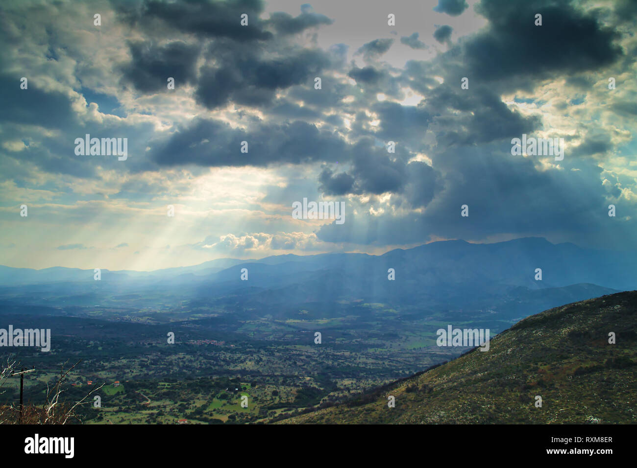 Sun rays through the clouds mountains and valley , in Arcadia Greece. Stock Photo