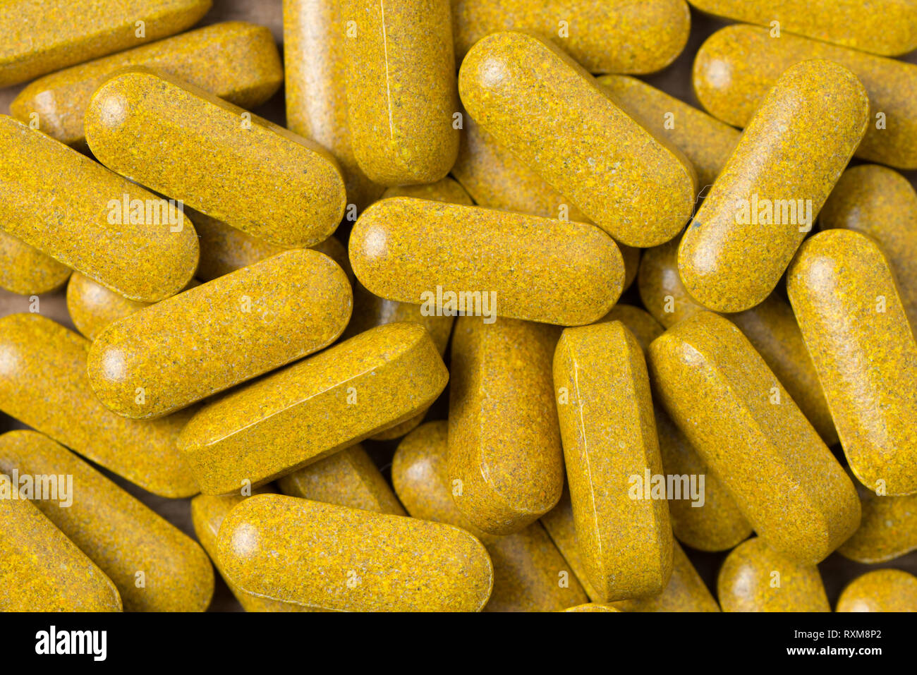 Close up turmeric and ginger root dietary supplement tablets Stock Photo
