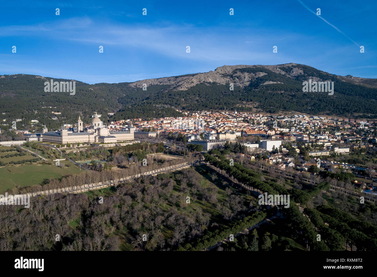 Aerial view of the Monastery of El Escorial at sunrise in spring with the Guadarrama mountains at the bottom Stock Photo