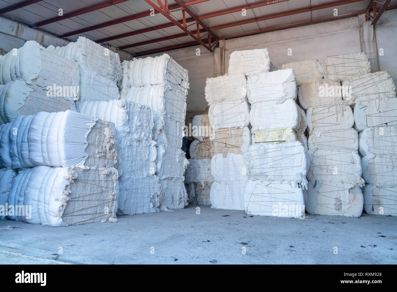 Interior of a storehouse .Stacked waste textile scraps In Bales Stock Photo