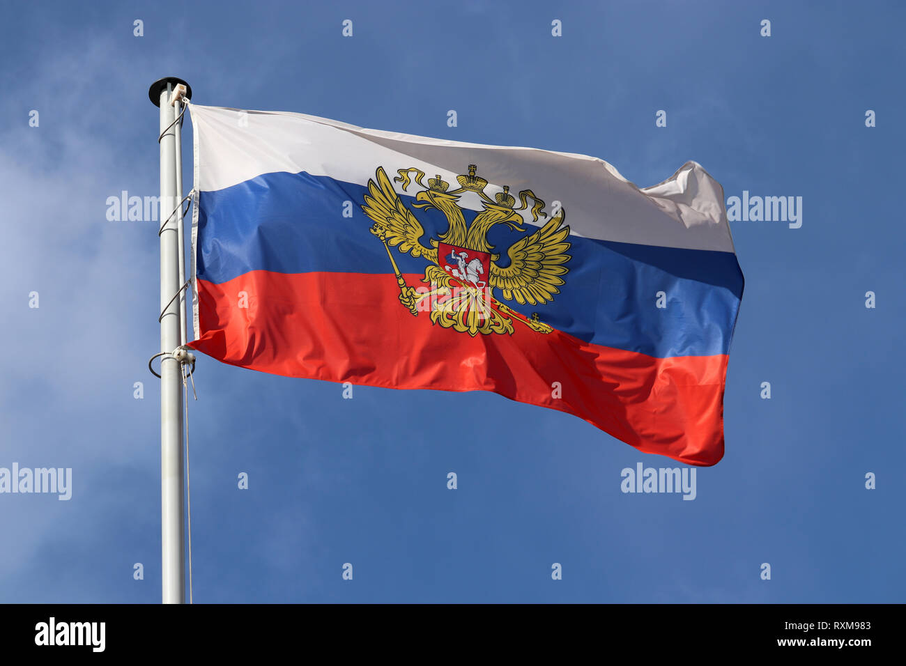 Russian flag waving against the blue sky and white clouds. Symbol of Russia, russian authorities concept Stock Photo