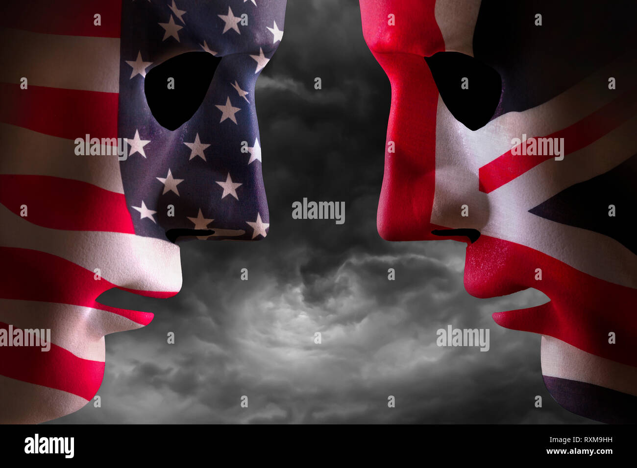 Head to head USA and UK faces with flag textures over the faces. Stormy clouds background. Stock Photo