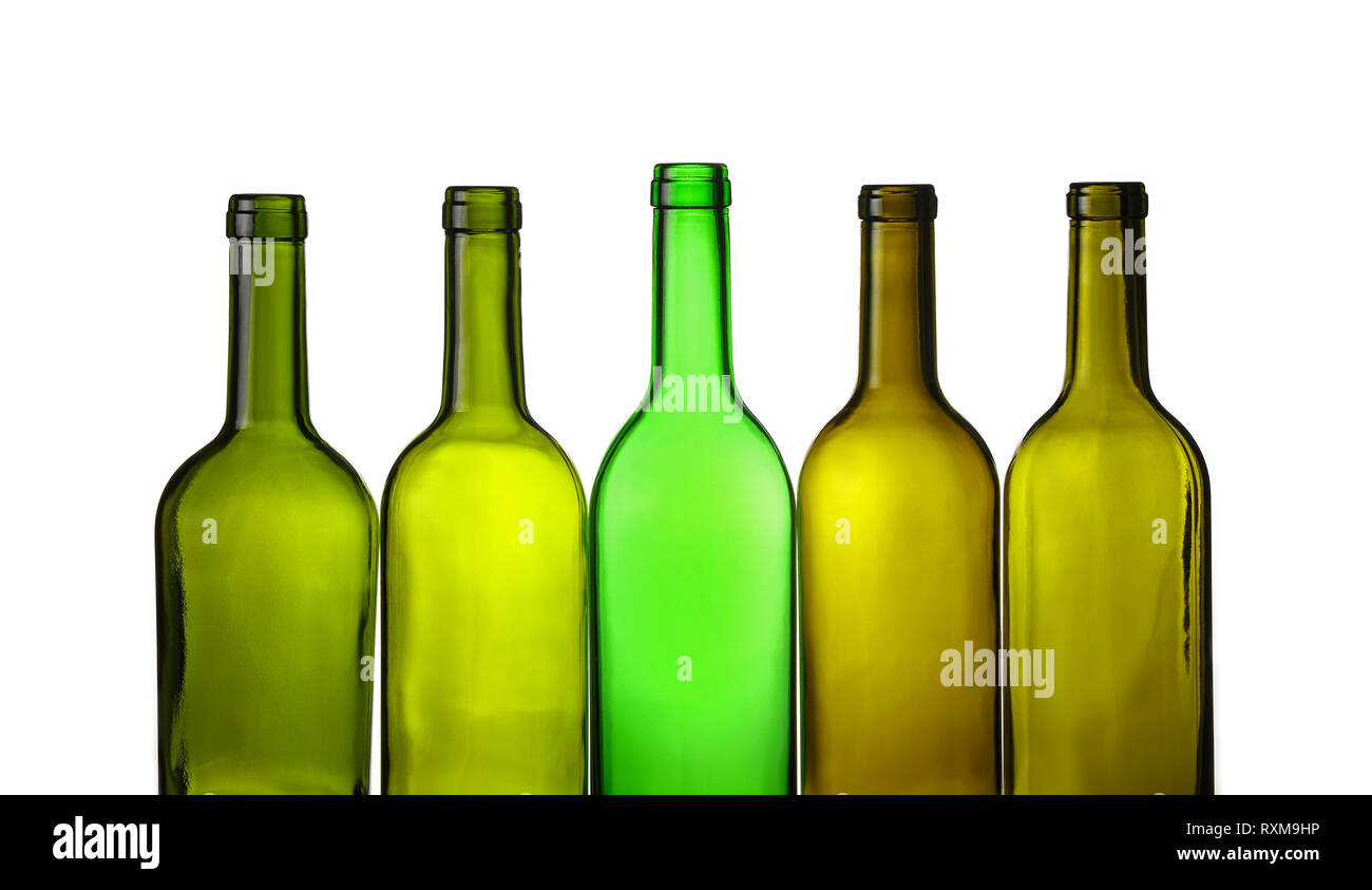 Close up group of five empty washed green glass wine bottles in a row isolated on white background, low angle side view Stock Photo