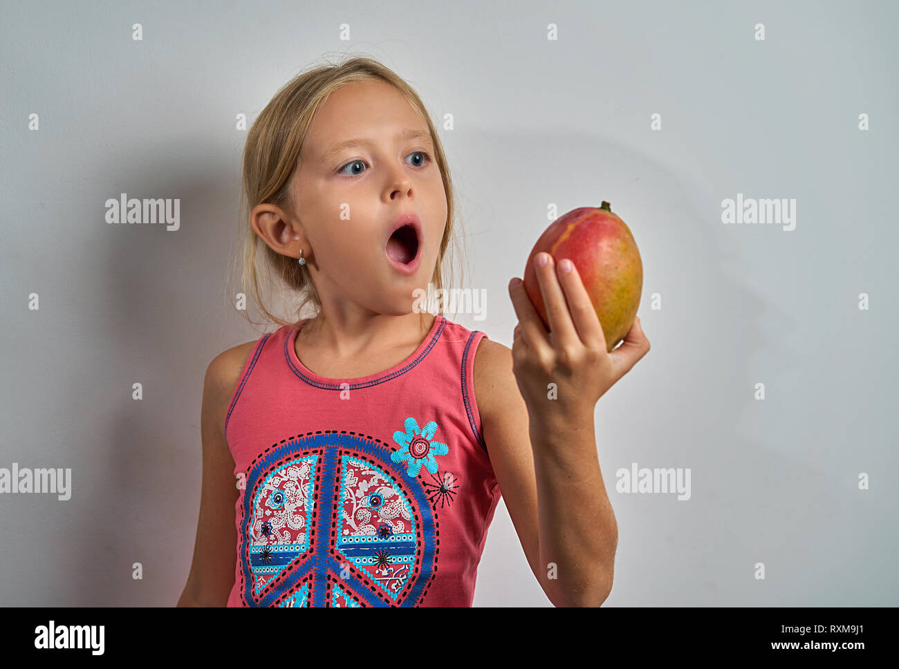 little girl eating mango Stock Photo Alamy