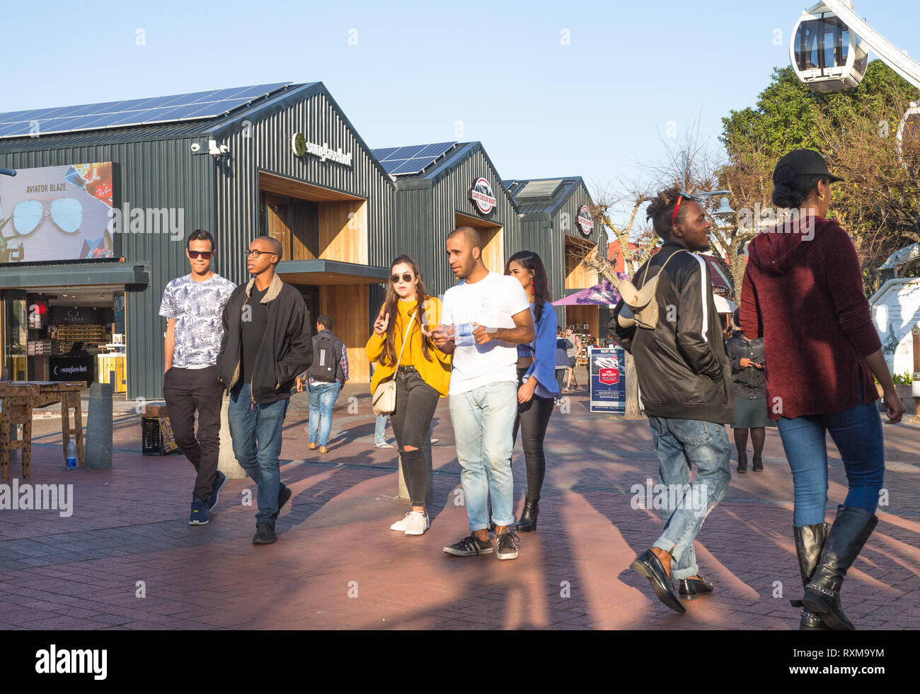 trendy young people at the V&A Waterfront in Cape Town, South Africa during  a Winter day at sunset Stock Photo - Alamy