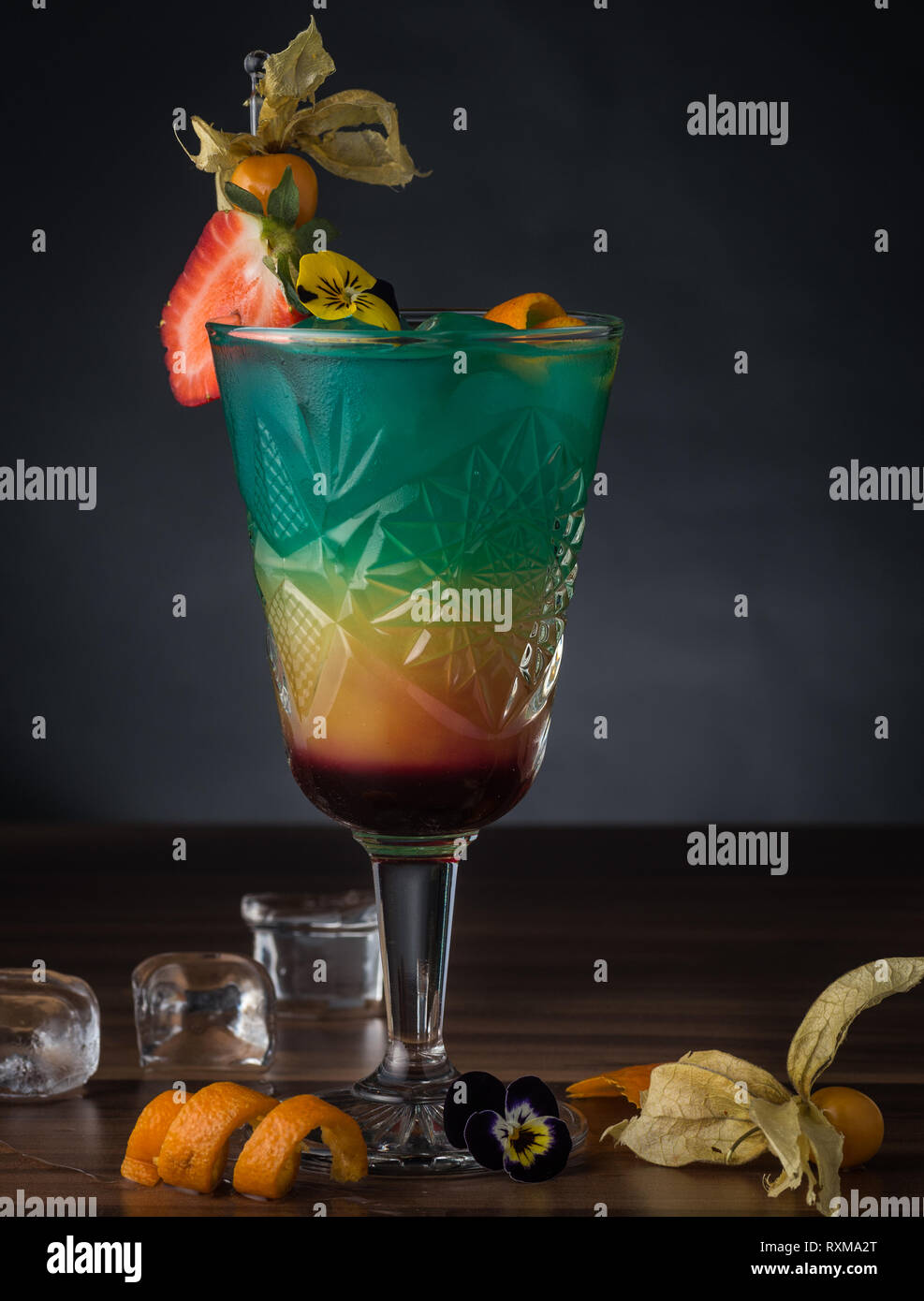 Colour Cocktail on dark wooden background Stock Photo - Alamy