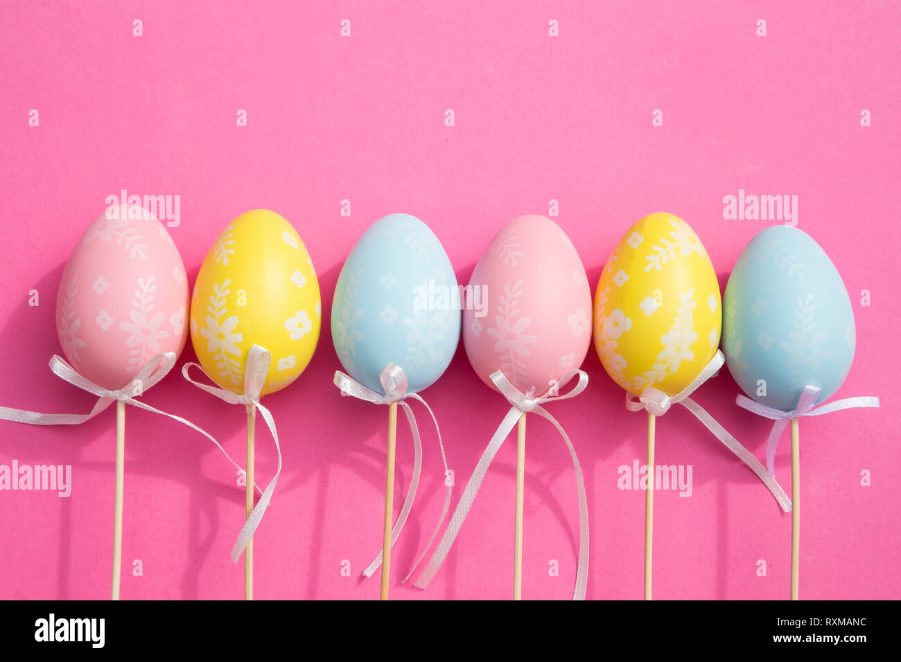 Colorful Easter eggs on pink background Stock Photo