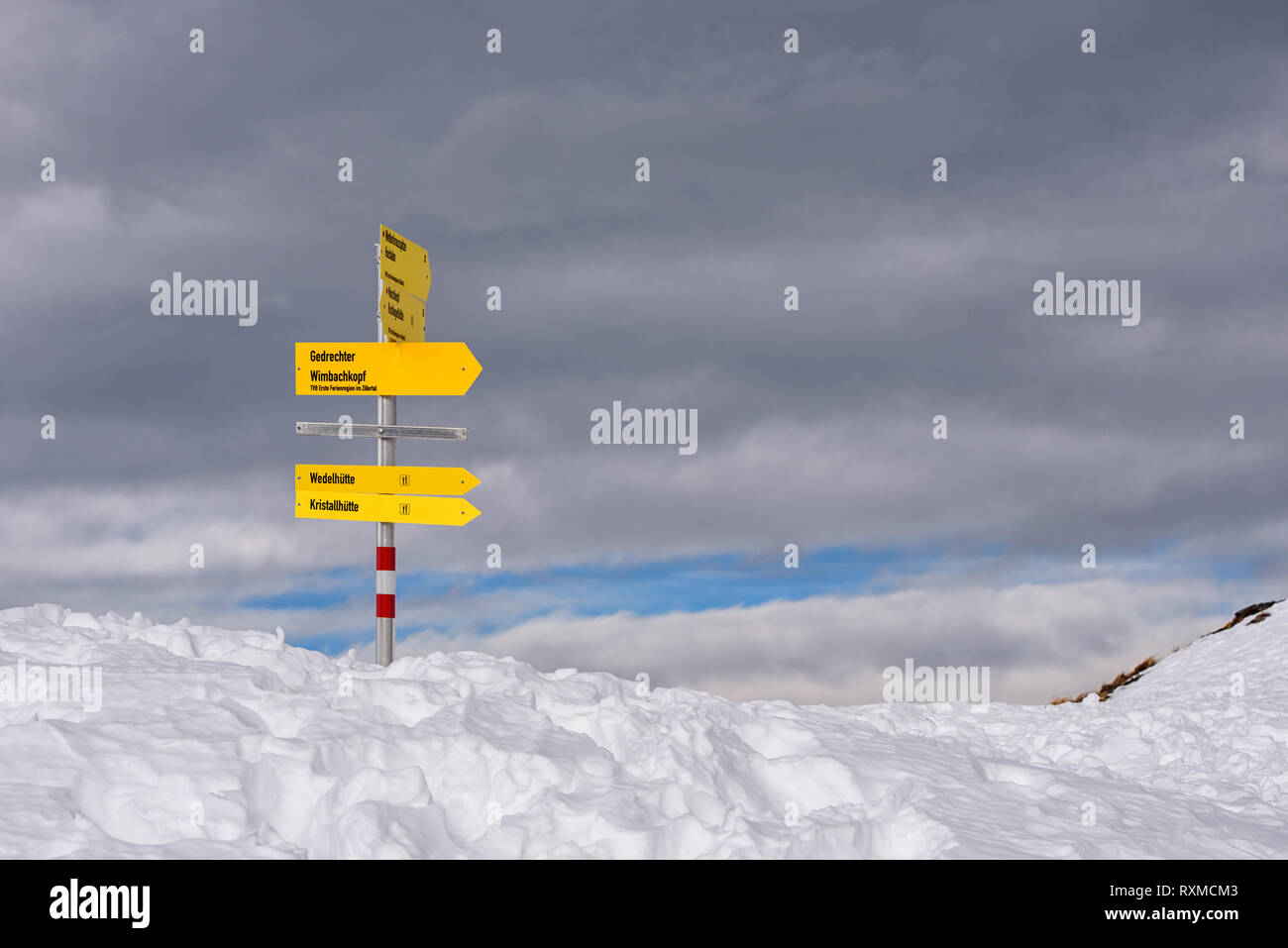 hiking information signs high in the mountains covered in snow in Tirol, Austria Stock Photo