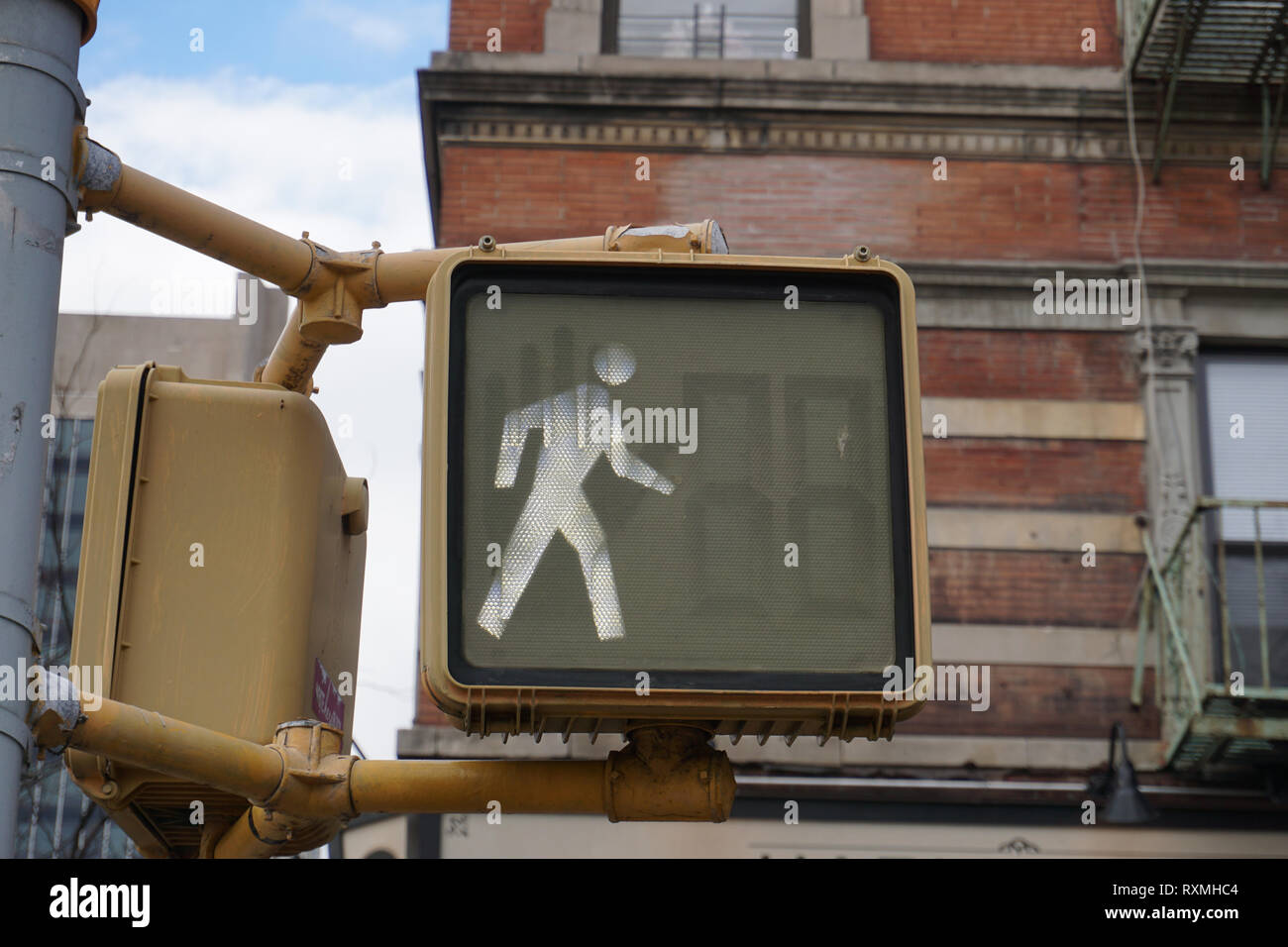 Pedestrian traffic light in New York, it's OK to cross. Stock Photo