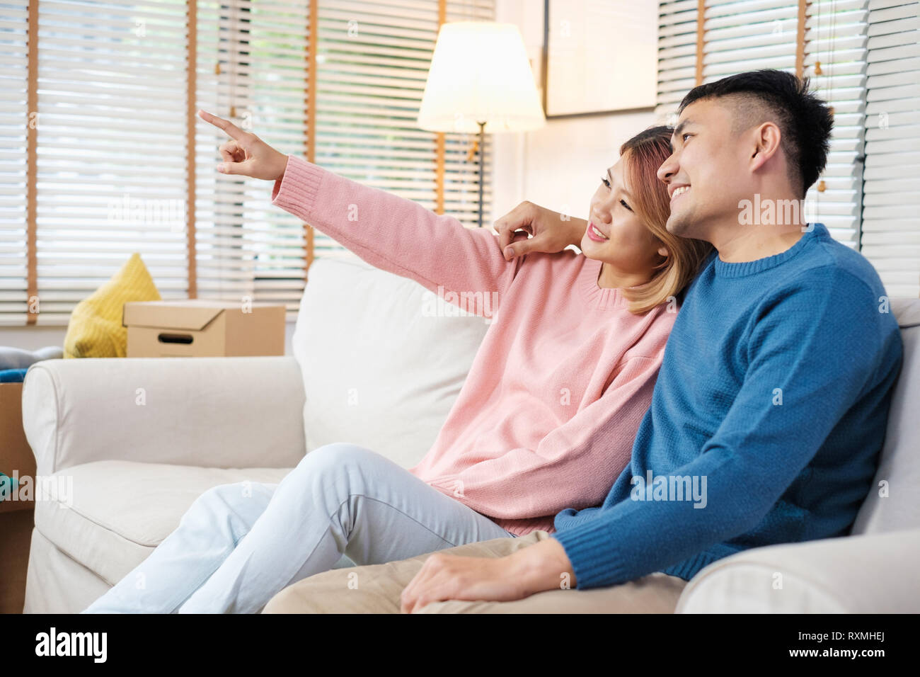 Asian couple planning to decorate house after moving to new home