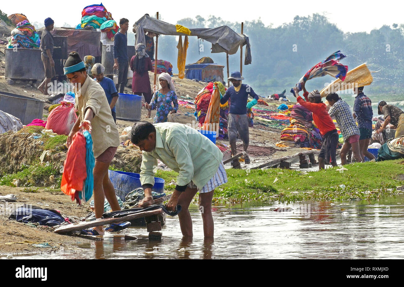AGRA, INDIA - SEPTEMBER 16, 2014: local community does laundry on the riverside of Yamuna river in Agra, India on September 16, 2014. Stock Photo