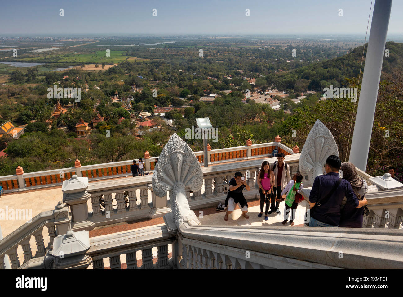 Cambodia, Phnom Penh, Oudong, visitors taking souvenir photograph on steps of Buddha’s eyebrow hair stupa Stock Photo