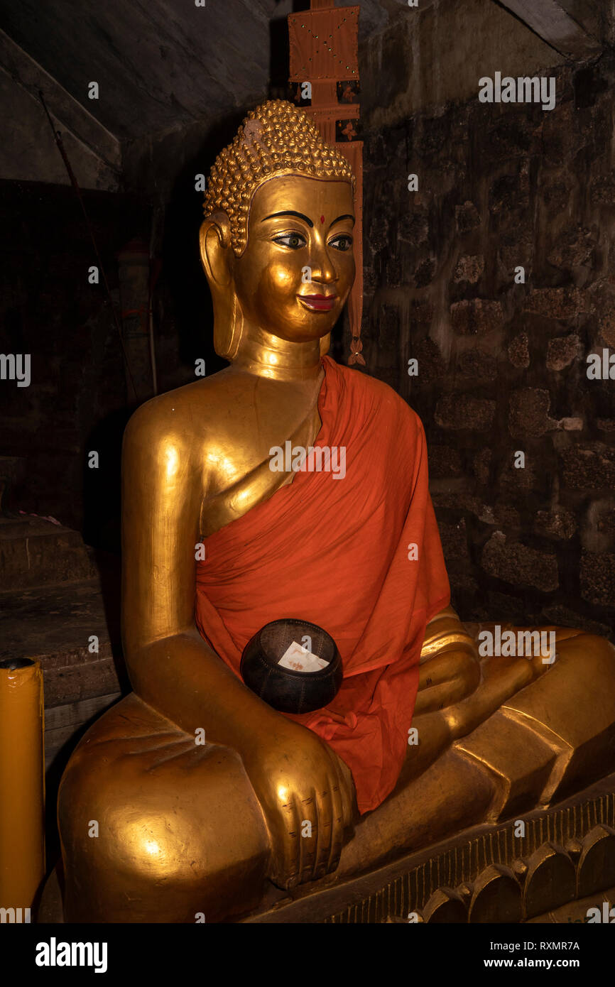 Cambodia, Phnom Penh, Oudong, Vihear Preah Ath Roes, golden Buddha statue with monks alms bowl and robe in reconstructed vihar Stock Photo