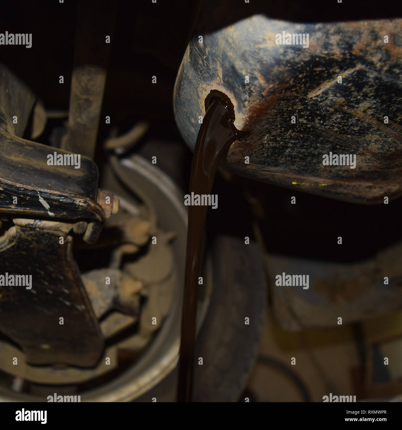 Drain the old oil from the engine through the drain plug. Changing the