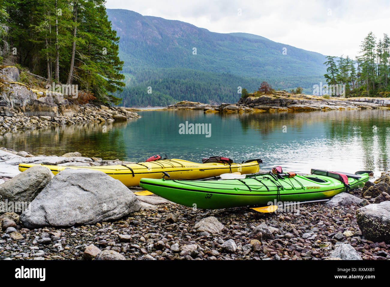 Two Kayaks along a shoreline in Desolation Sound, Sunshine Coast, British Columbia, Canada Stock Photo