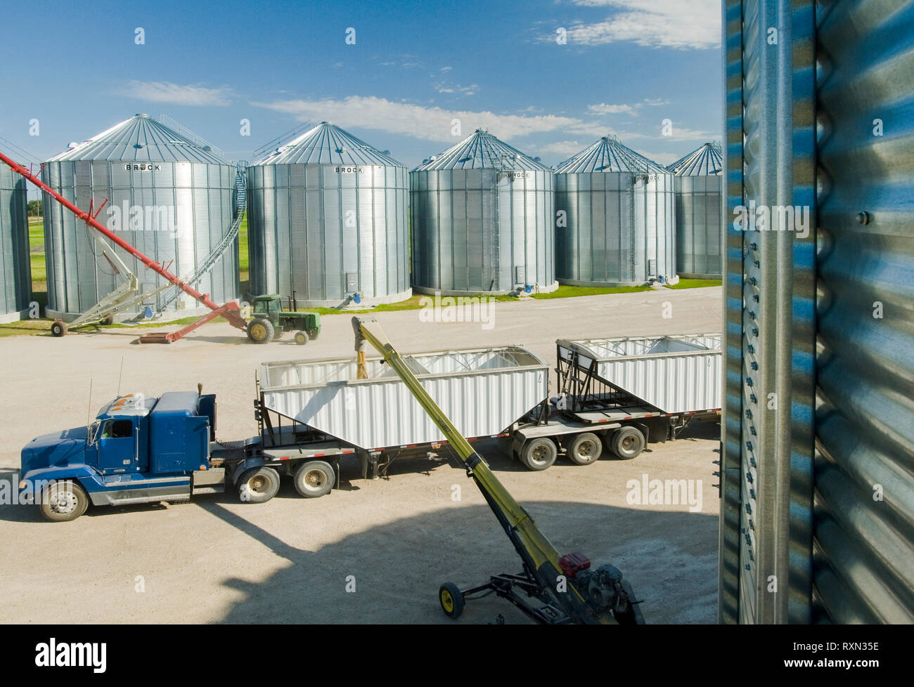 a super B grain truck being loaded with barley from grain storage bins near St. Jean, Manitoba