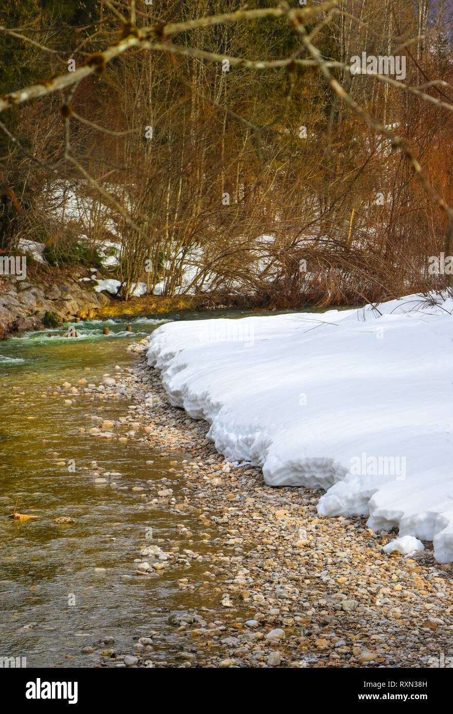 snowy winter river in bavaria, travel reit im winkl Stock Photo