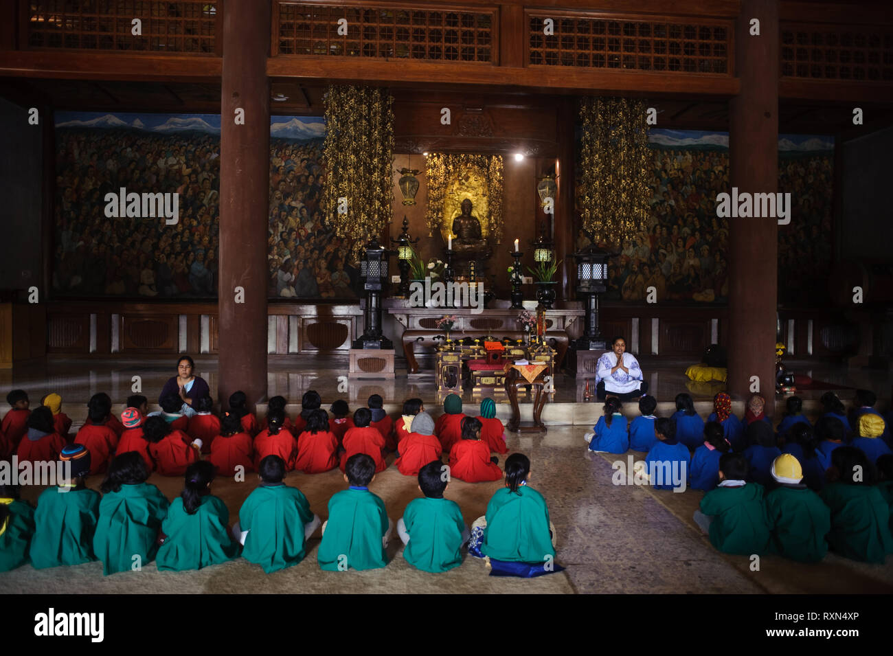 Schoolchildren are attending a course on buddhism in a buddhist temple ( India) Stock Photo