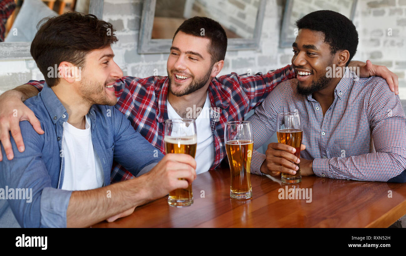 Friends hanging out and communicating in bar Stock Photo