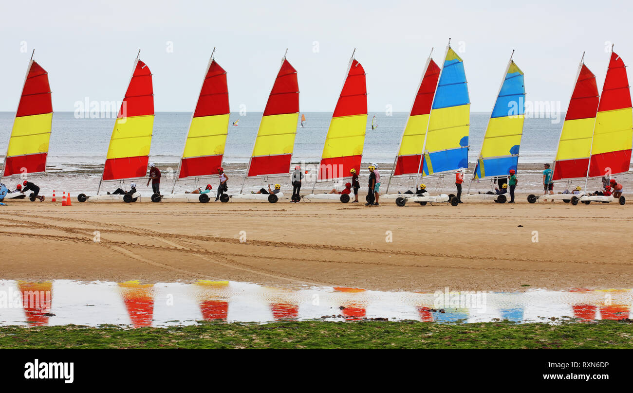 Young boys and girls on sand yachts during a practical class on beach sailing, Courseulles-sur-Mer Sailing School, Courseulles-sur-Mer, Normandy, France Stock Photo