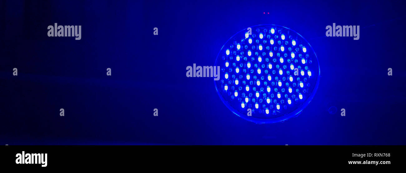 lamp with blue led lights shining in the dark, modern neon light, club