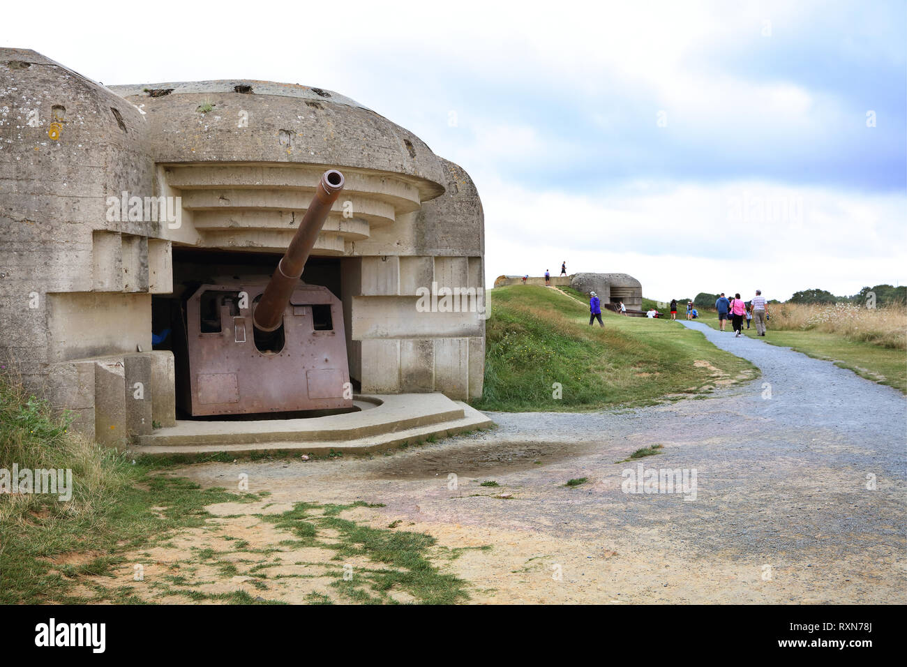 One of four 152-mm guns protected by a concrete casemate that was part of Germany's Atlantic Wall defense on D-Day at Longues-sur-Mer, Normandy, France Stock Photo