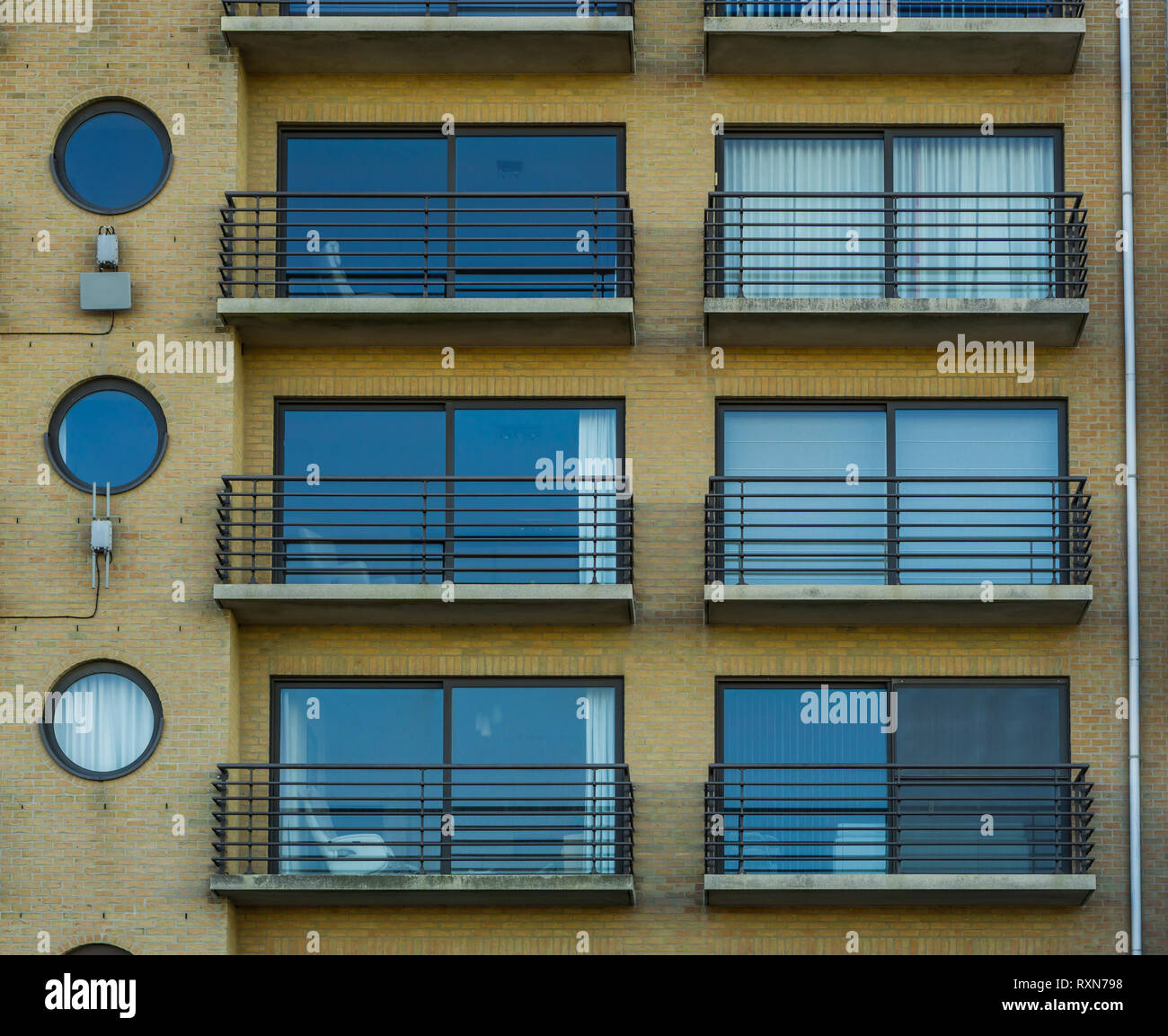 belgian apartments with windows and balconies, city architecture of