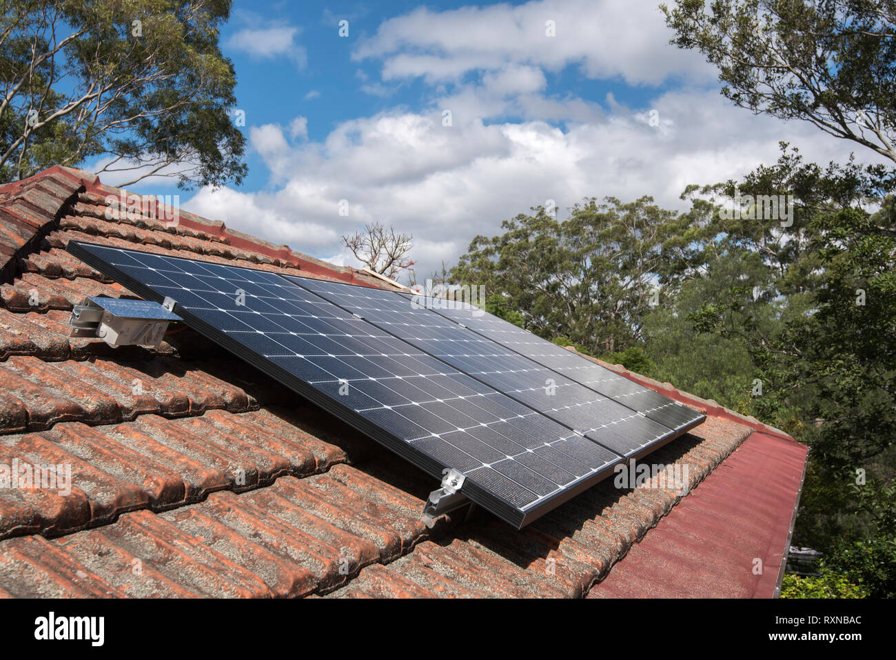 An array of roof top solar photo voltaic (PV) panels on a home in Sydney Australia. These panels are all installed with individual micro inverters. Stock Photo