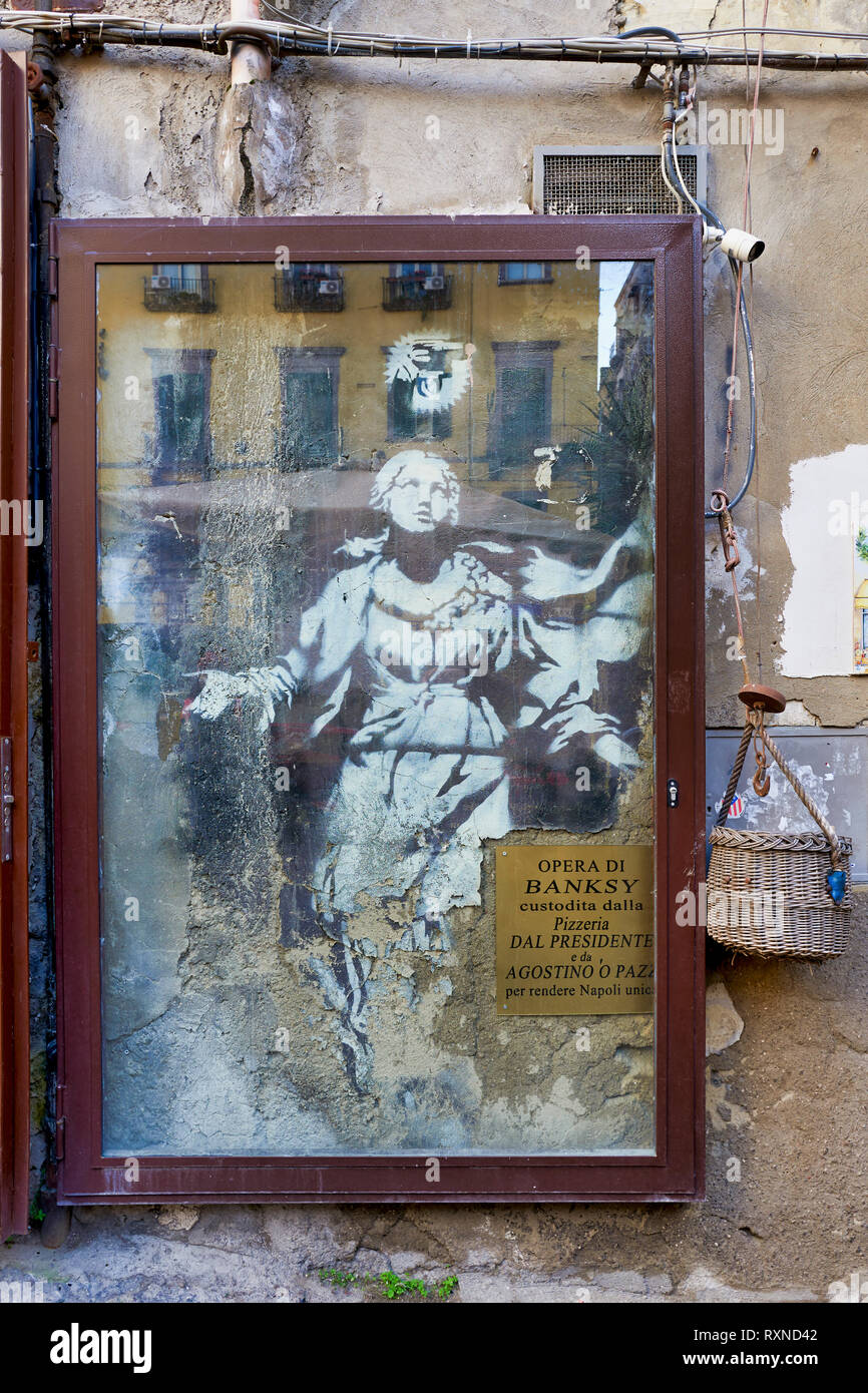 Naples Campania Italy. Famous street art by Banksy. Madonna con revolver (Mary with gun) Stock Photo