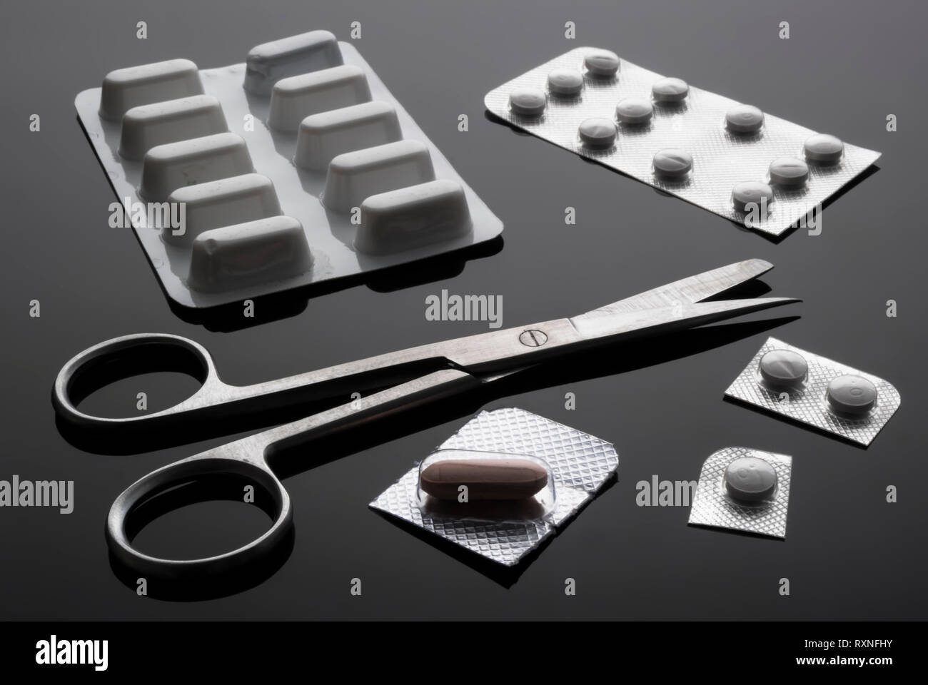 Monodose medication pills with scissors, conceptual image, horizontal composition Stock Photo