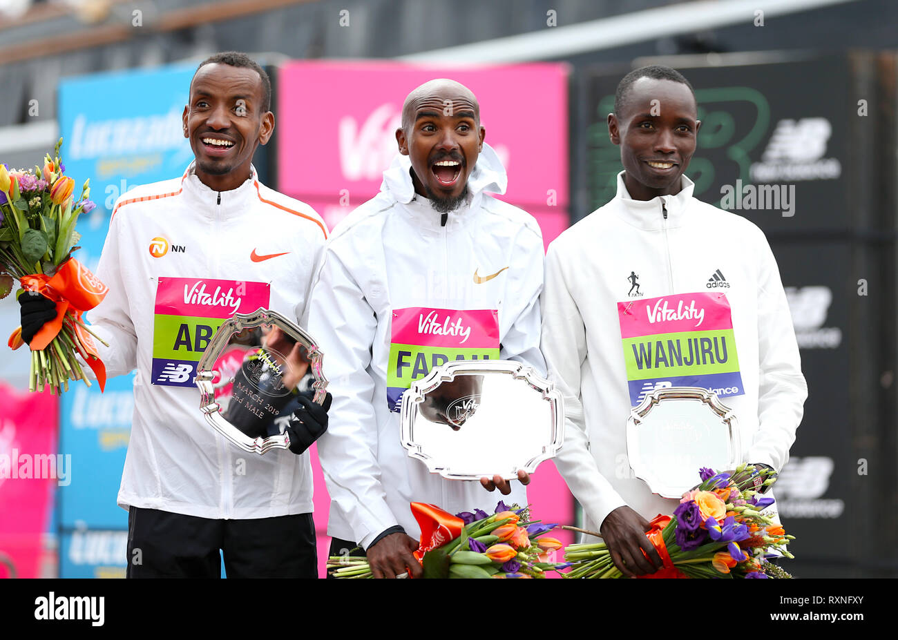 Mo Farah winner of the men's race (centre) with Bashir Abdi who finished secoond (left) and Daniel Wanjiru who finished third during the Vitality Big Half in London. Stock Photo