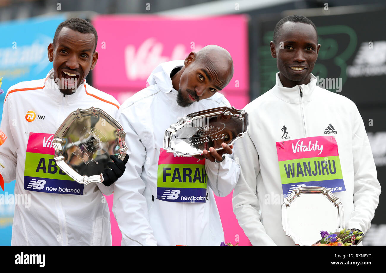 Mo Farah winner of the men's race (centre) with Bashir Abdi who finished secoond (left) and Daniel Wanjiru who finished third during the Vitality Big Half in London. Stock Photo