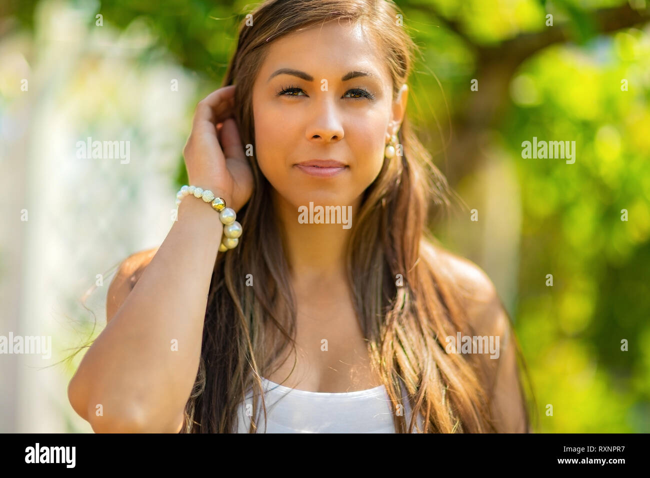 Close-up of a beautiful woman standing in her garden at home Stock Photo