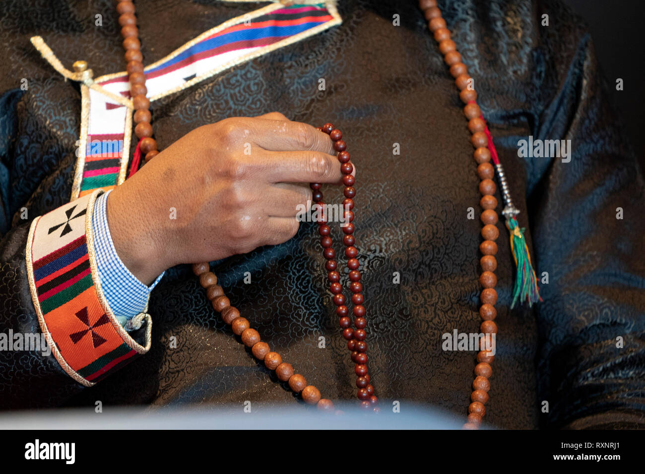 Tibetan monk bracelet on buddihst hand detail Stock Photo