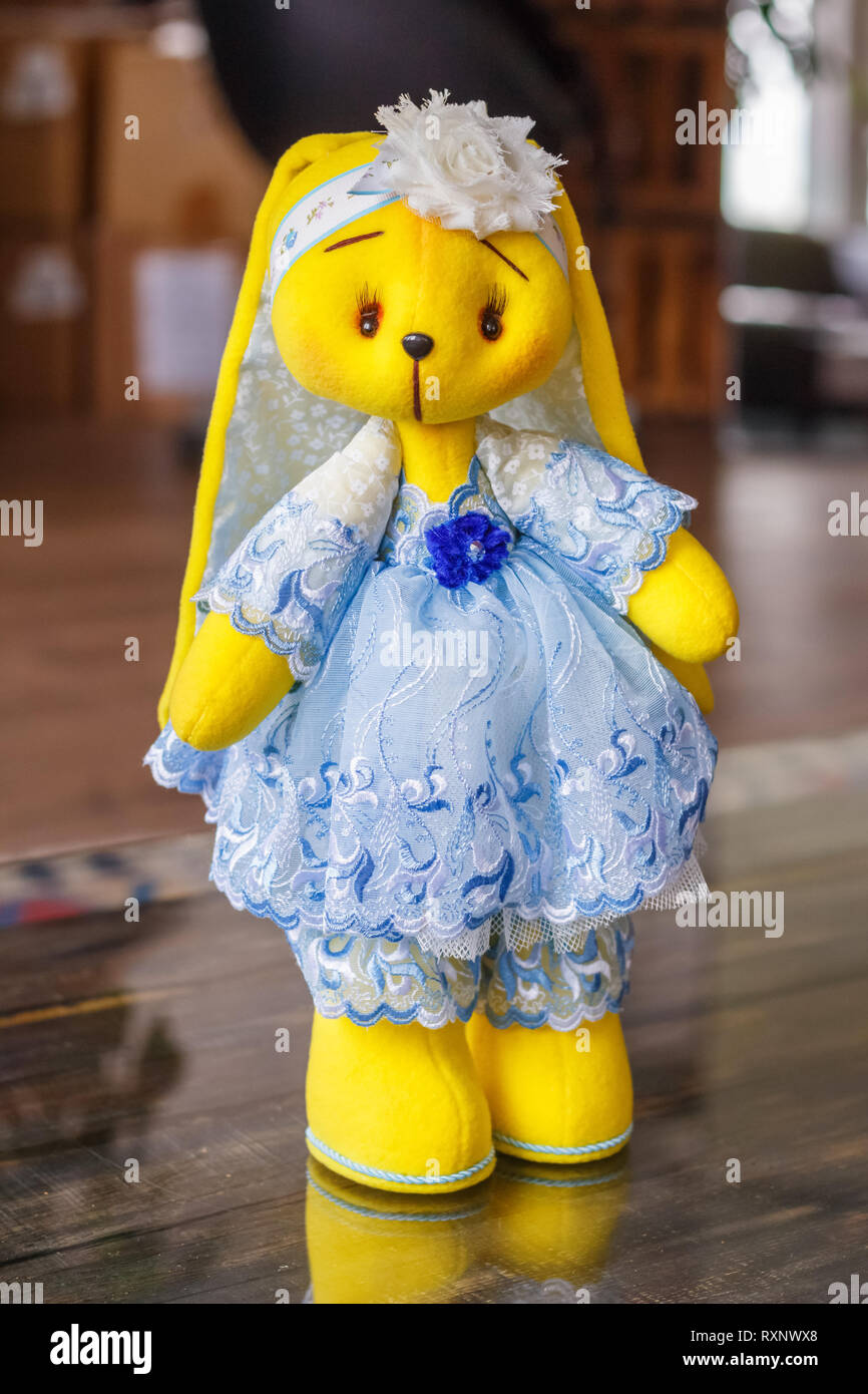Handmade doll yellow bunny in a blue dress Stock Photo - Alamy